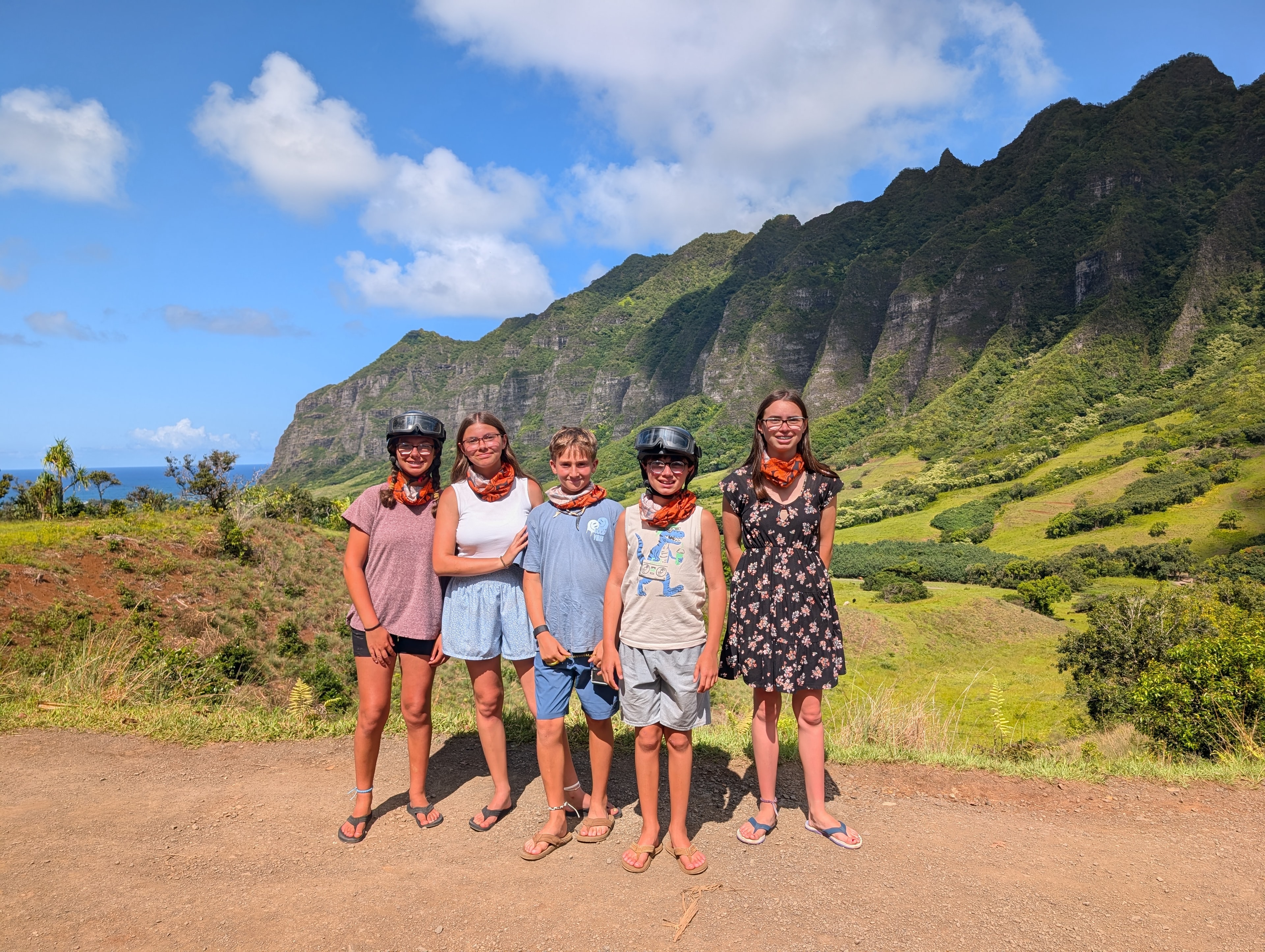 Five kids at Kualoa Ranch with dramatic mountain backdrop