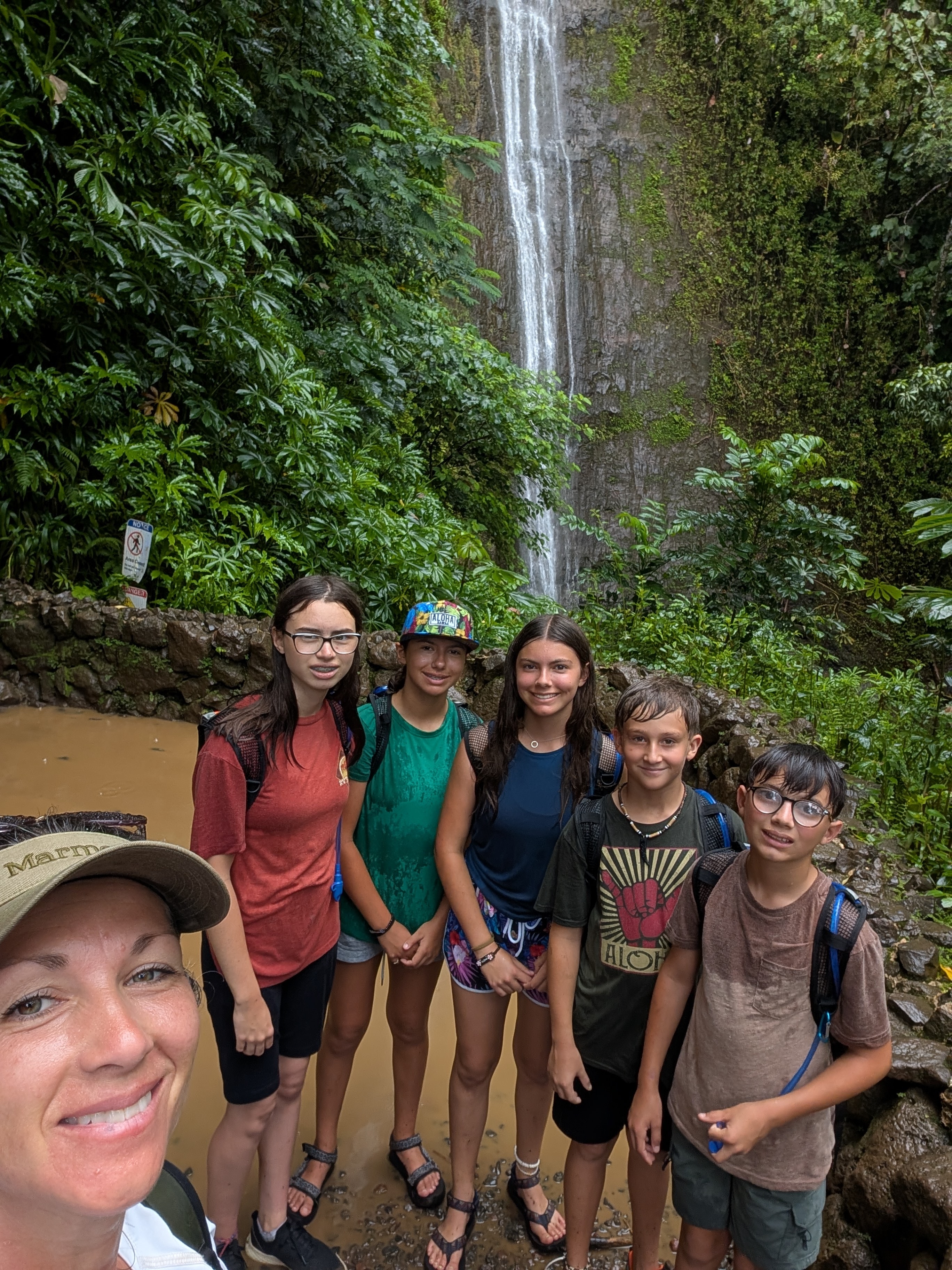 Family selfie at a waterfall on a hike in Oahu