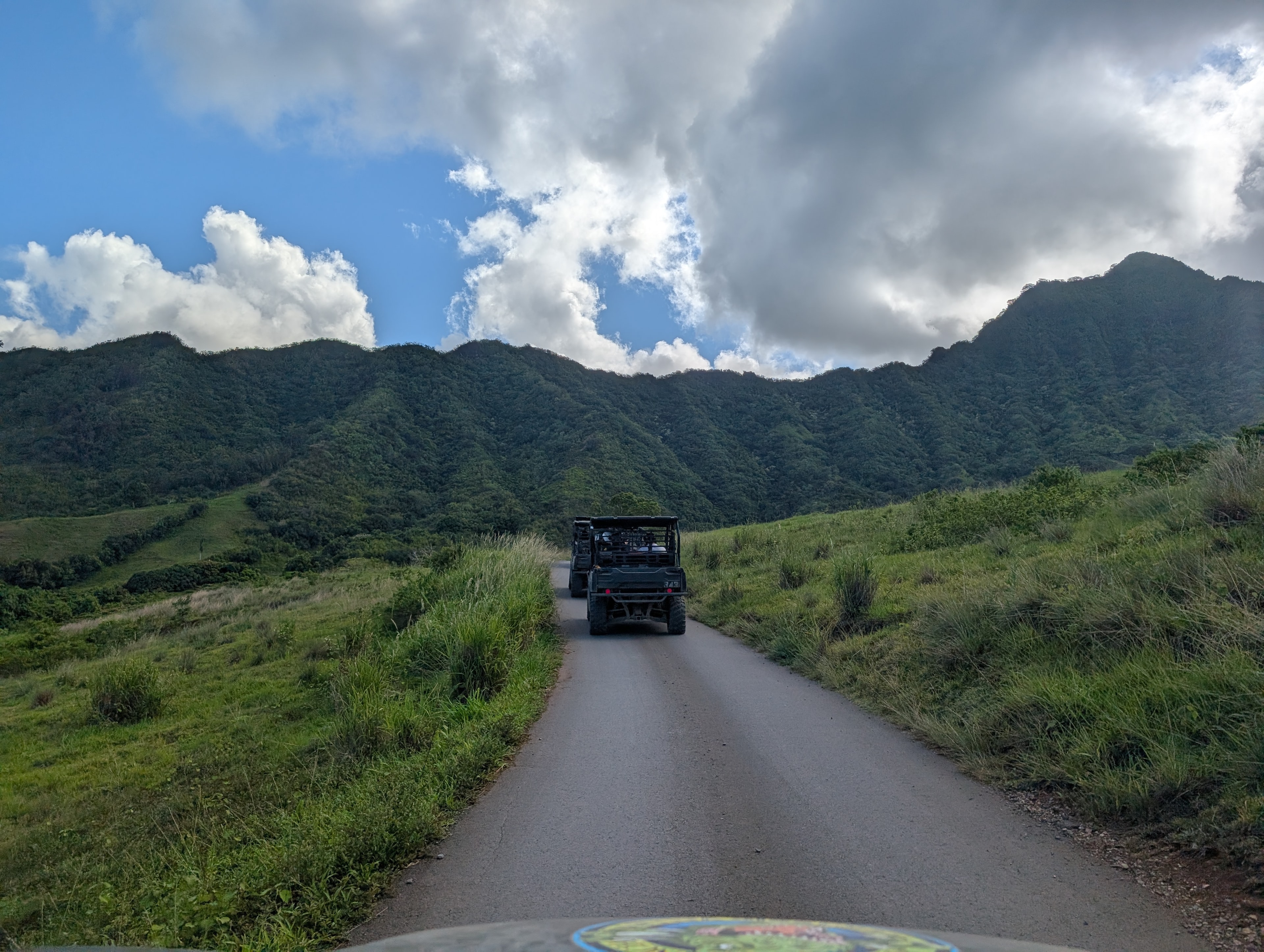 Off-road vehicles on a lush mountain trail road
