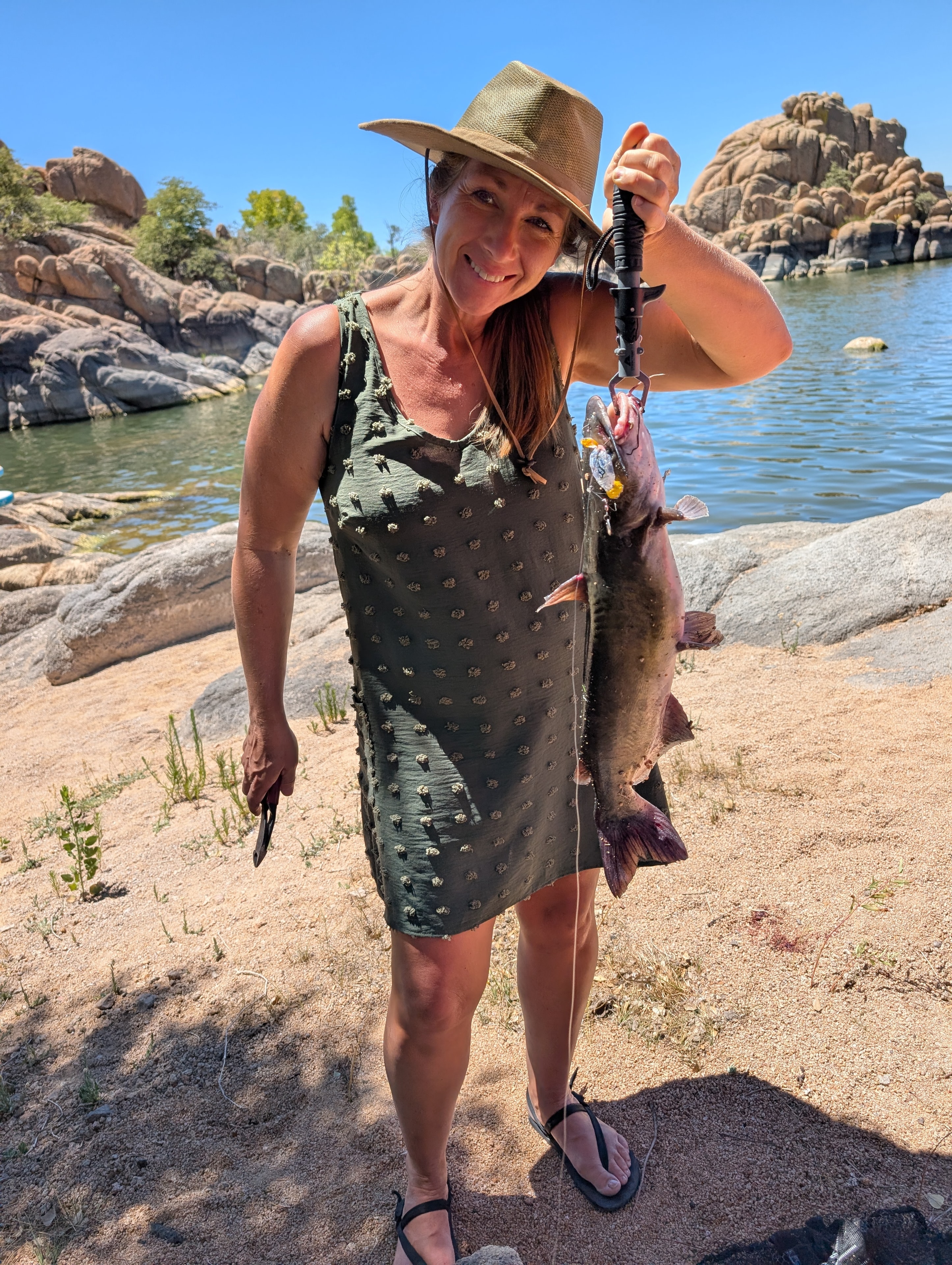 Mom holding a big catfish at Watson Lake